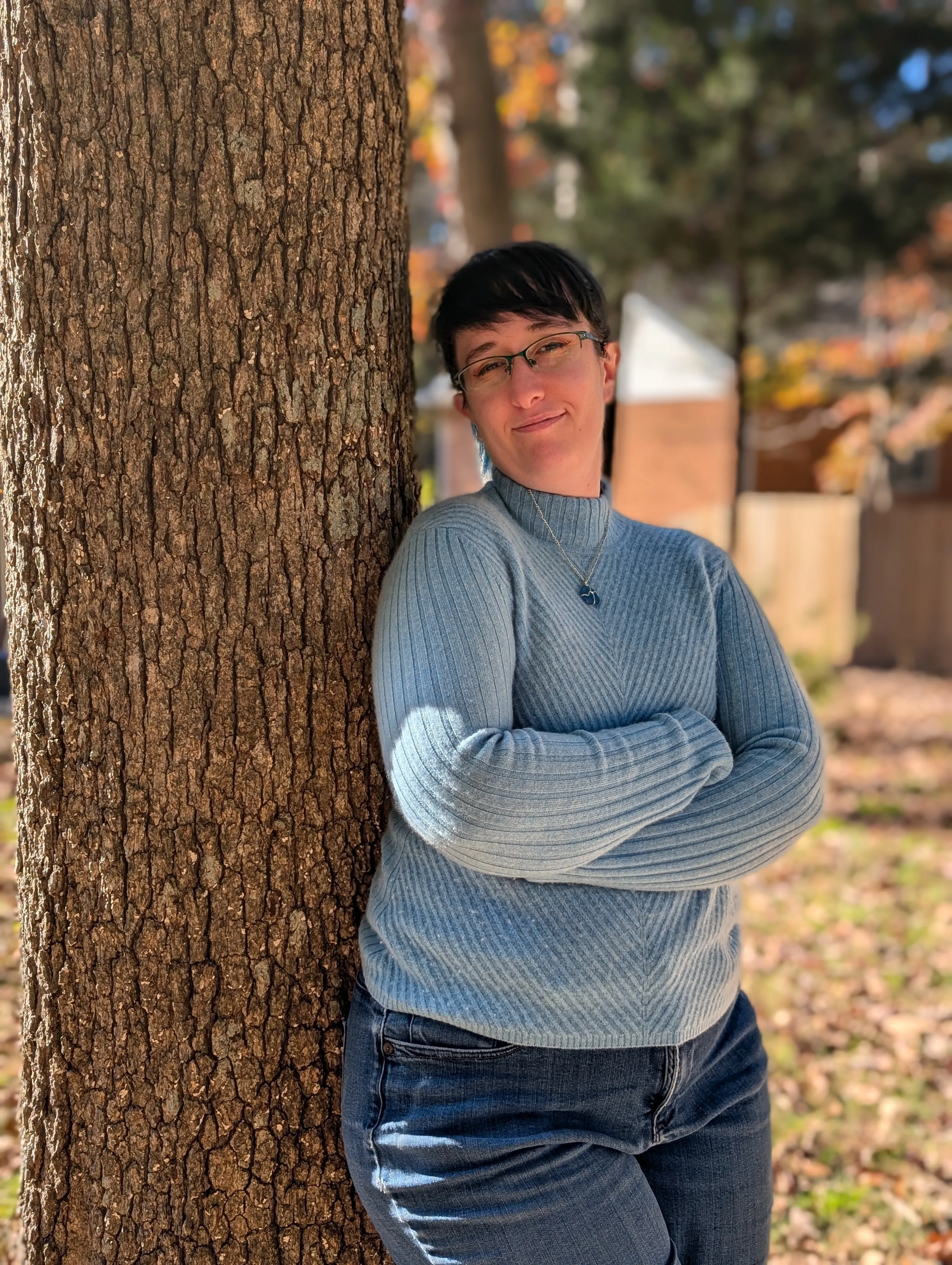 Lacey leaning against a tree